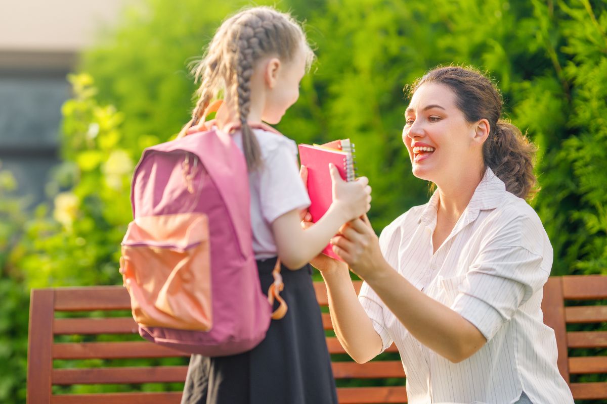 A picture of a mom sending her child to school. 