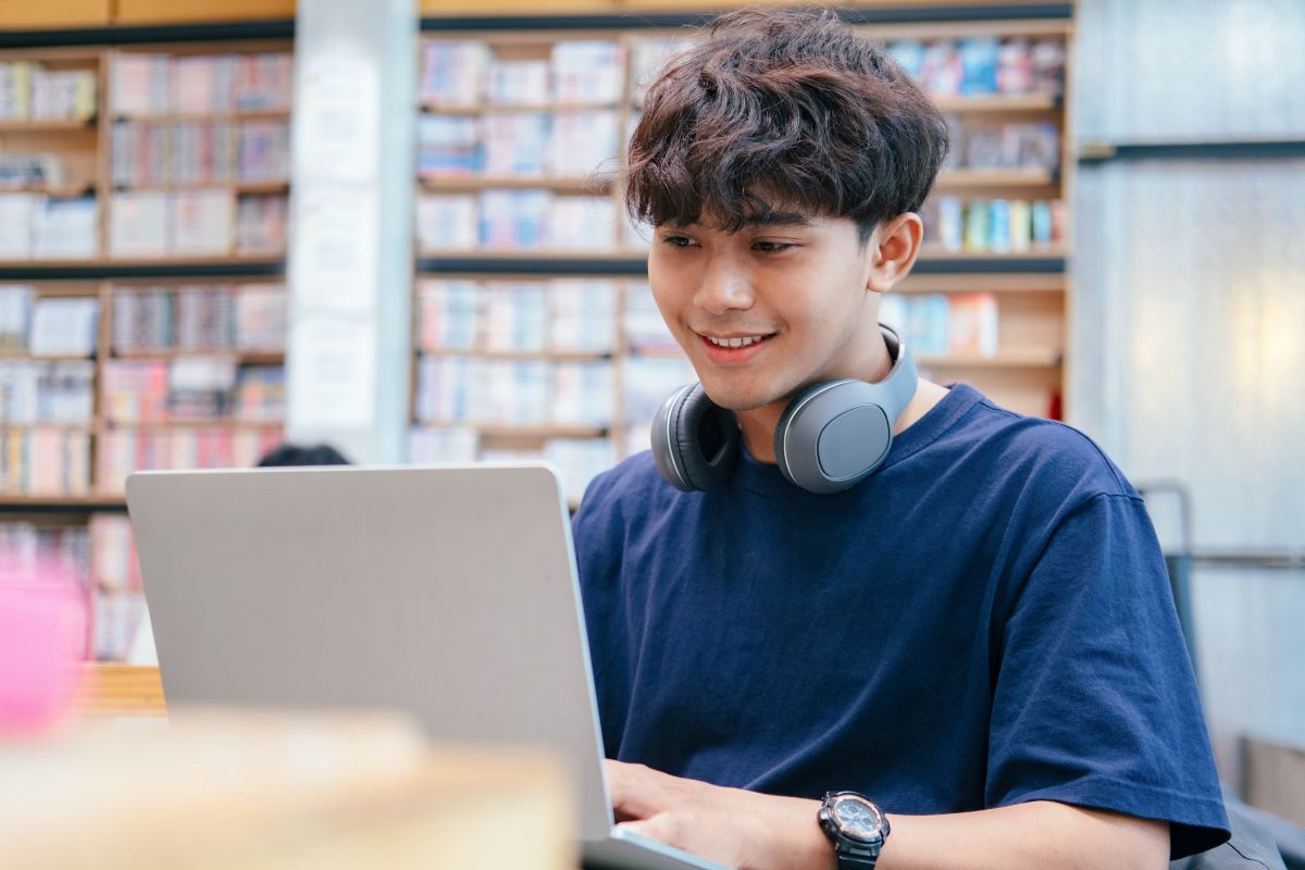 A picture of someone looking at their laptop. 