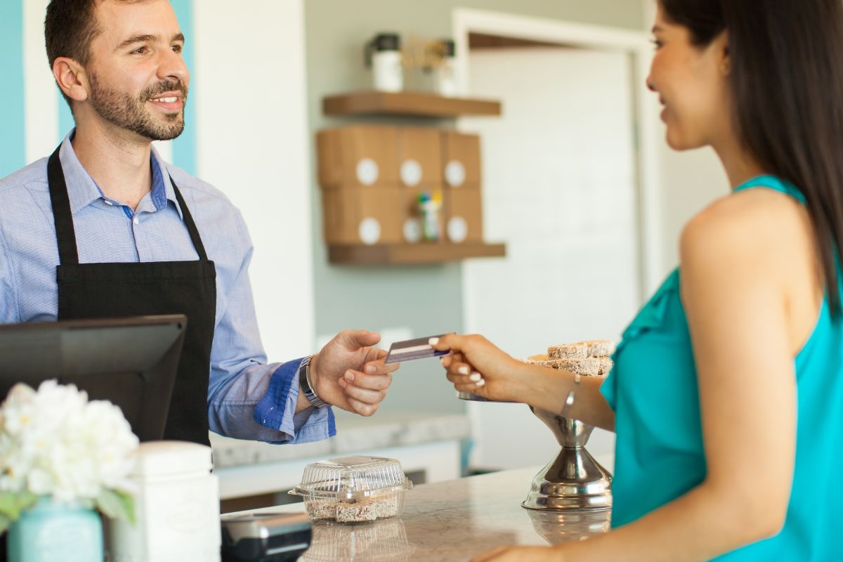 A picture of paying someone through credit card. 