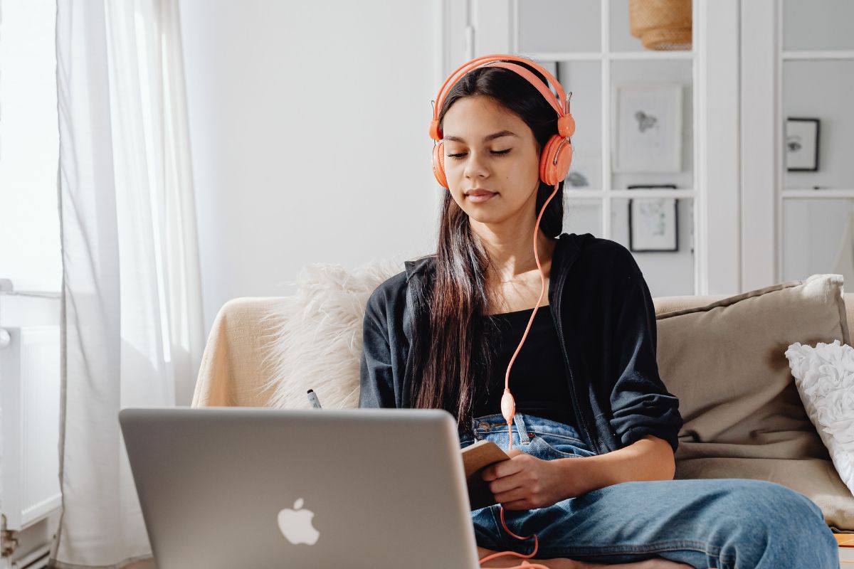 A picture of someone looking at their laptop. 