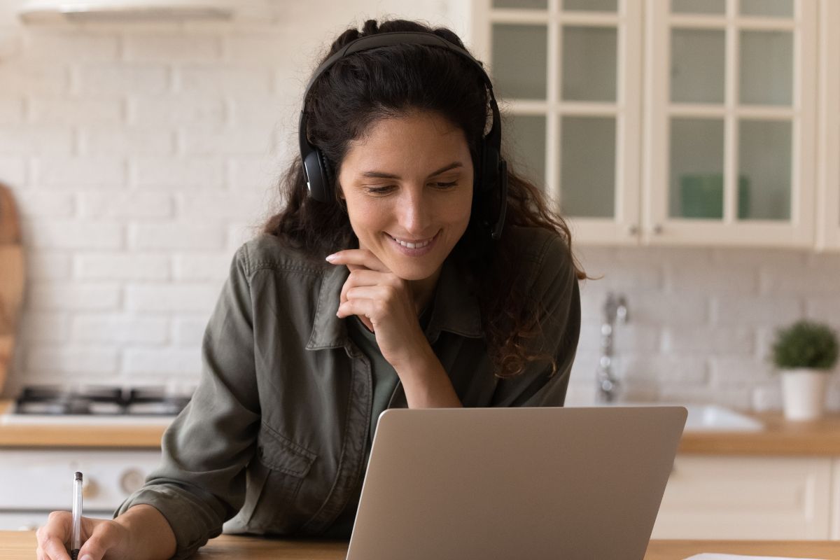 A picture of someone looking at their laptop.