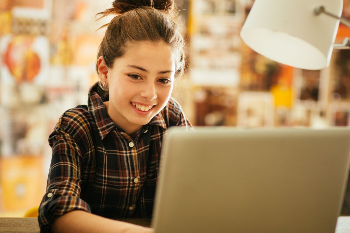 A picture of someone looking at their laptop.