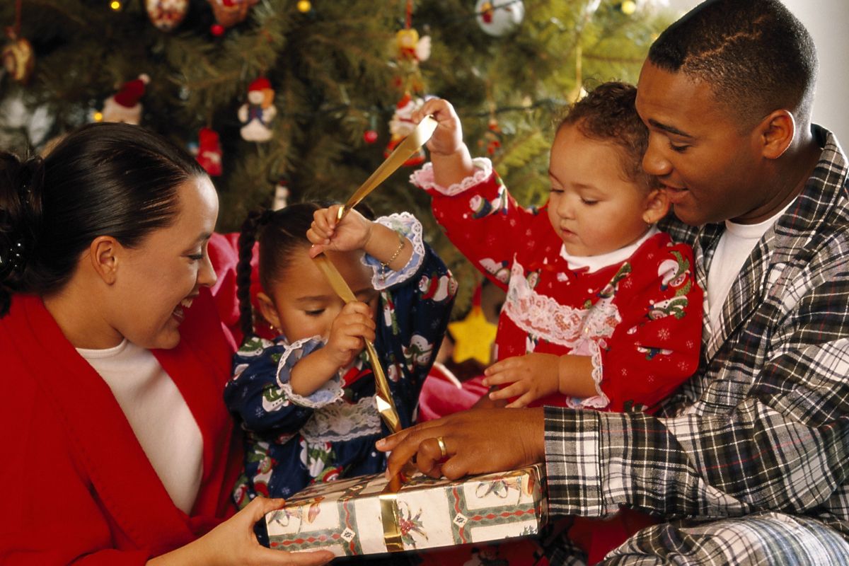 A picture of a family unwrapping gifts. 