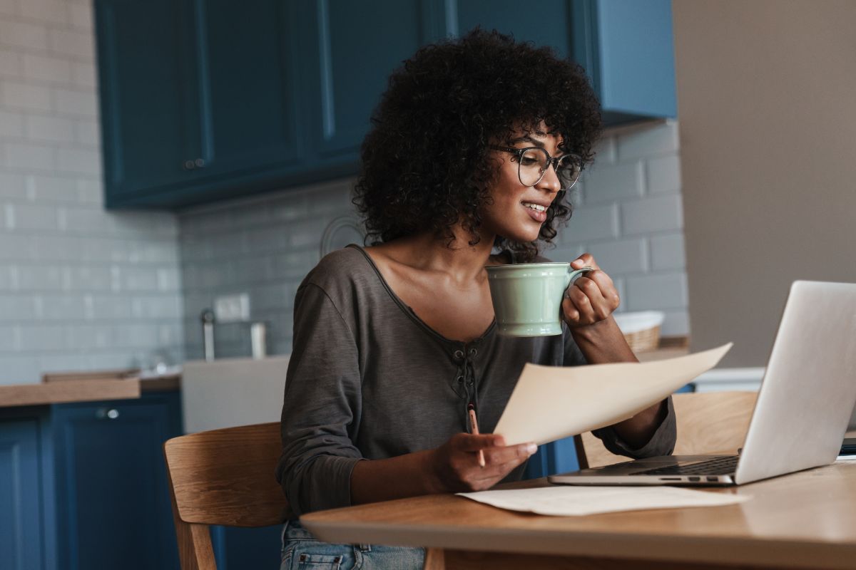A picture of someone relaxing while looking at their laptop.