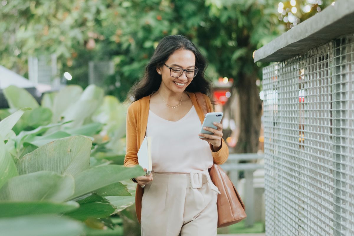 A picture of a woman smiling while walking.