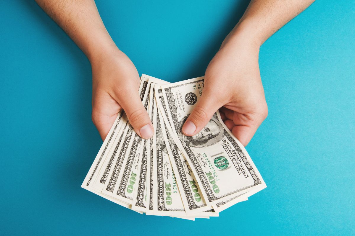 A picture of someone counting money. 