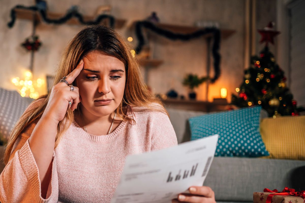 Picture of a lady stressed about money at Christmas.