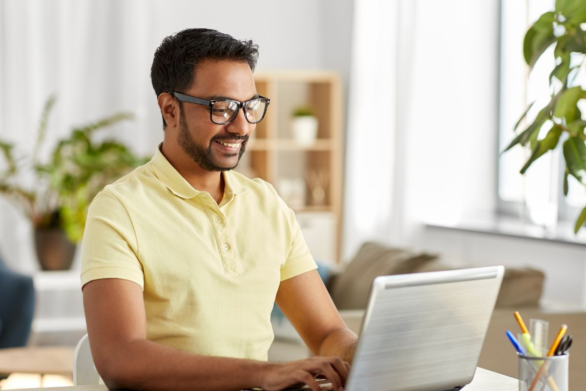 A picture of a smart man using their laptop.