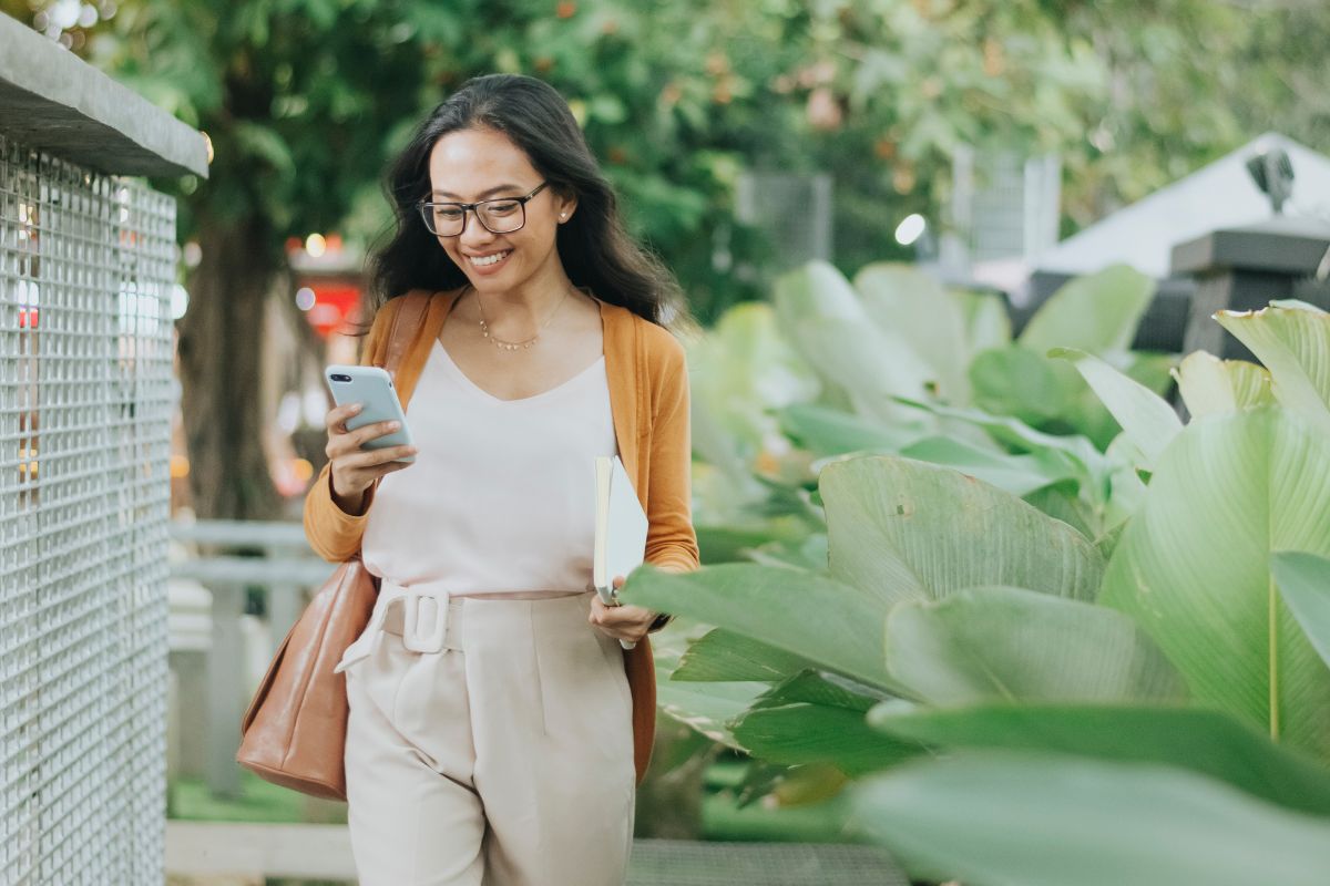 A picture of someone smiling while using their phone.