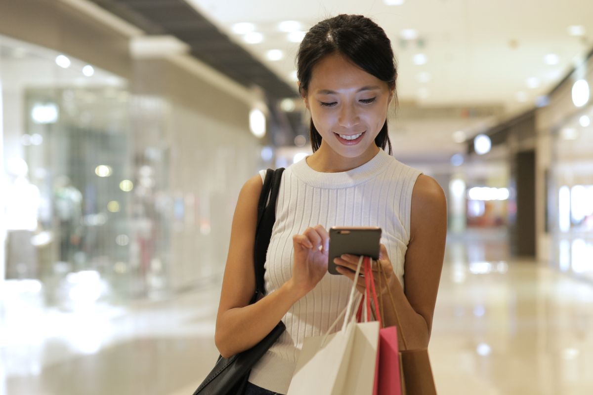 A picture of someone using their phone after shopping.