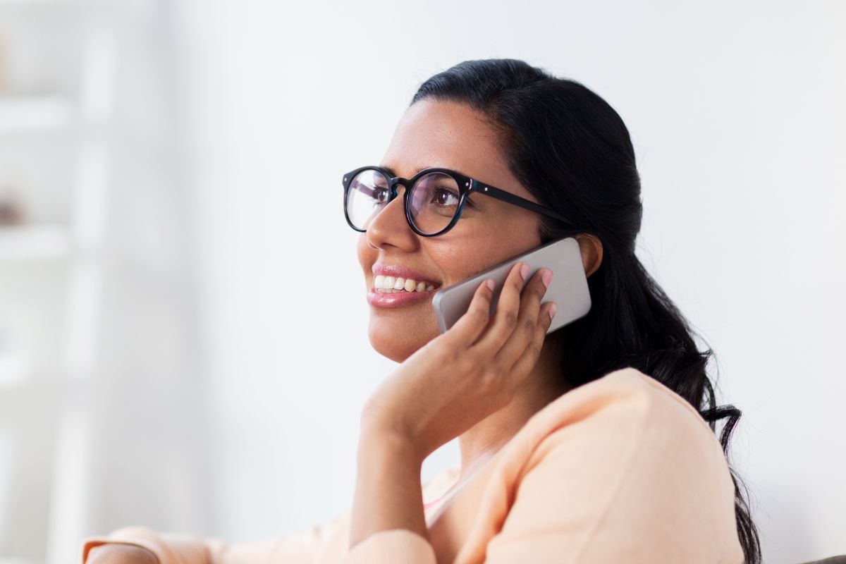 A picture of someone smiling while calling.