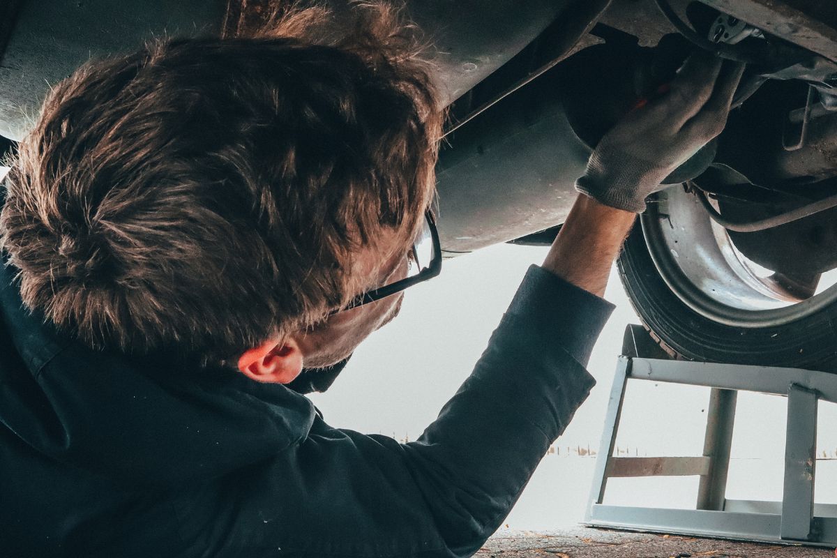 A picture of someone fixing their car.