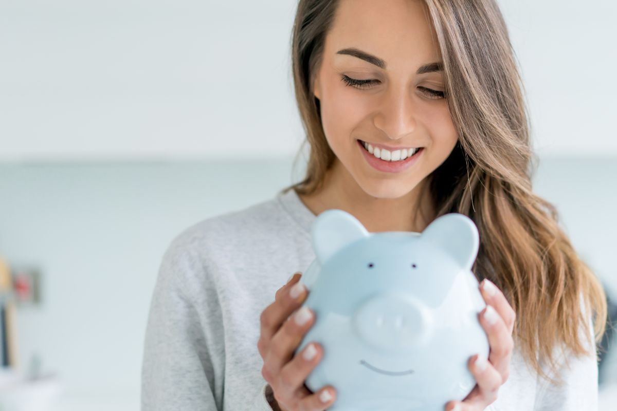 A picture of someone holding a piggy bank.