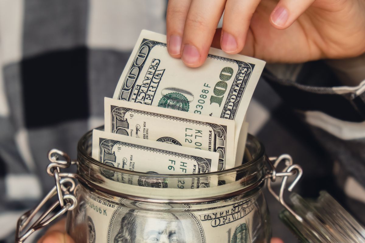 A picture of someone saving $100 bills.