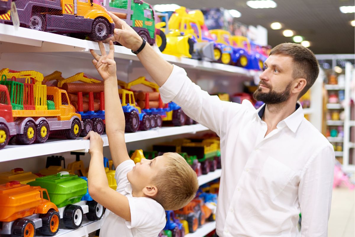 A picture of a child and an adult in the toy department.