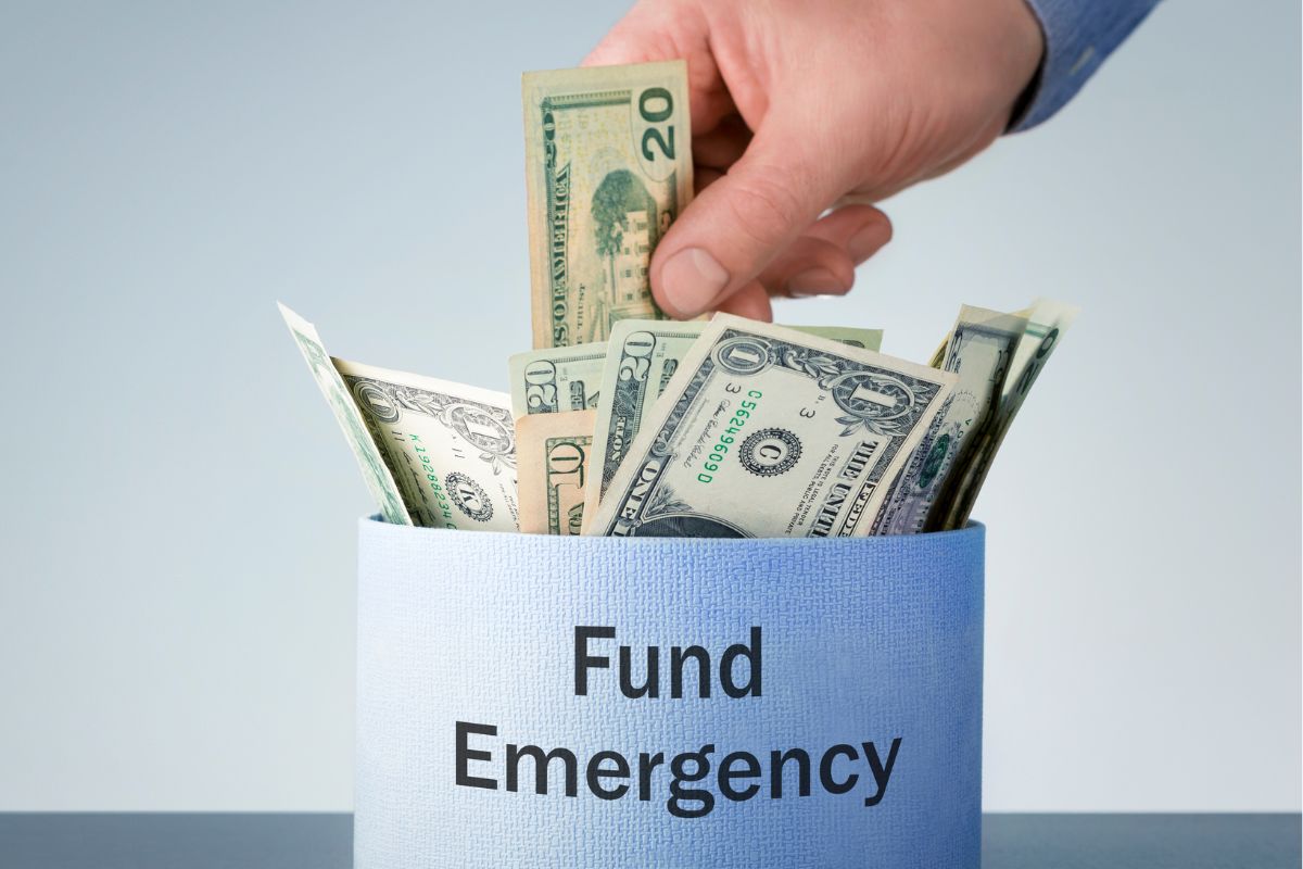 Image of a man's hand digging into his emergency fund.