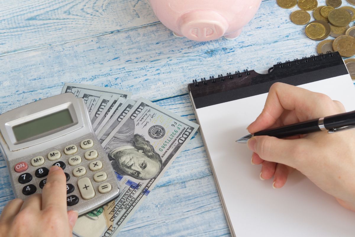 Picture of a woman's hand adjusting her budget.