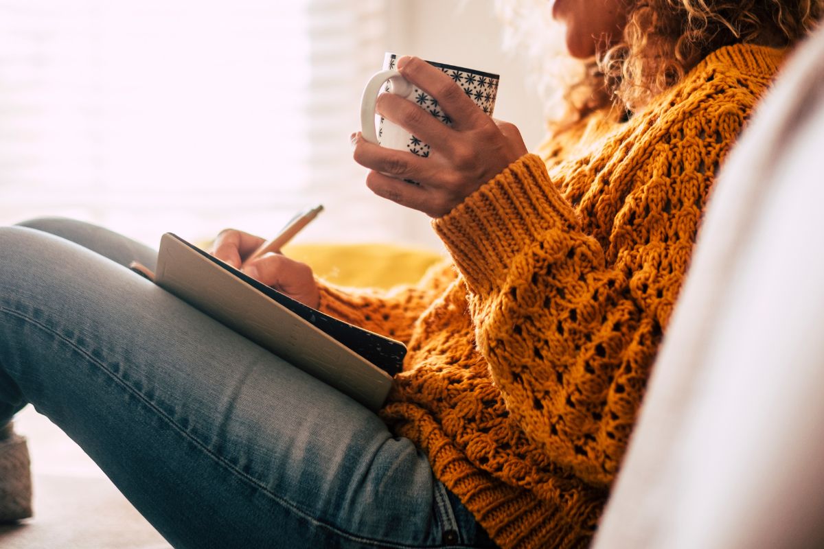 A picture of someone writing while relaxing.