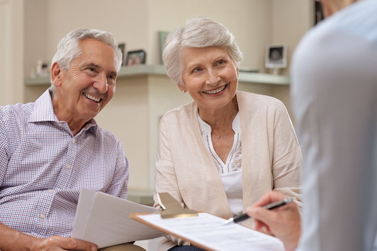 A picture of an elderly couple talking to a financial advisor.