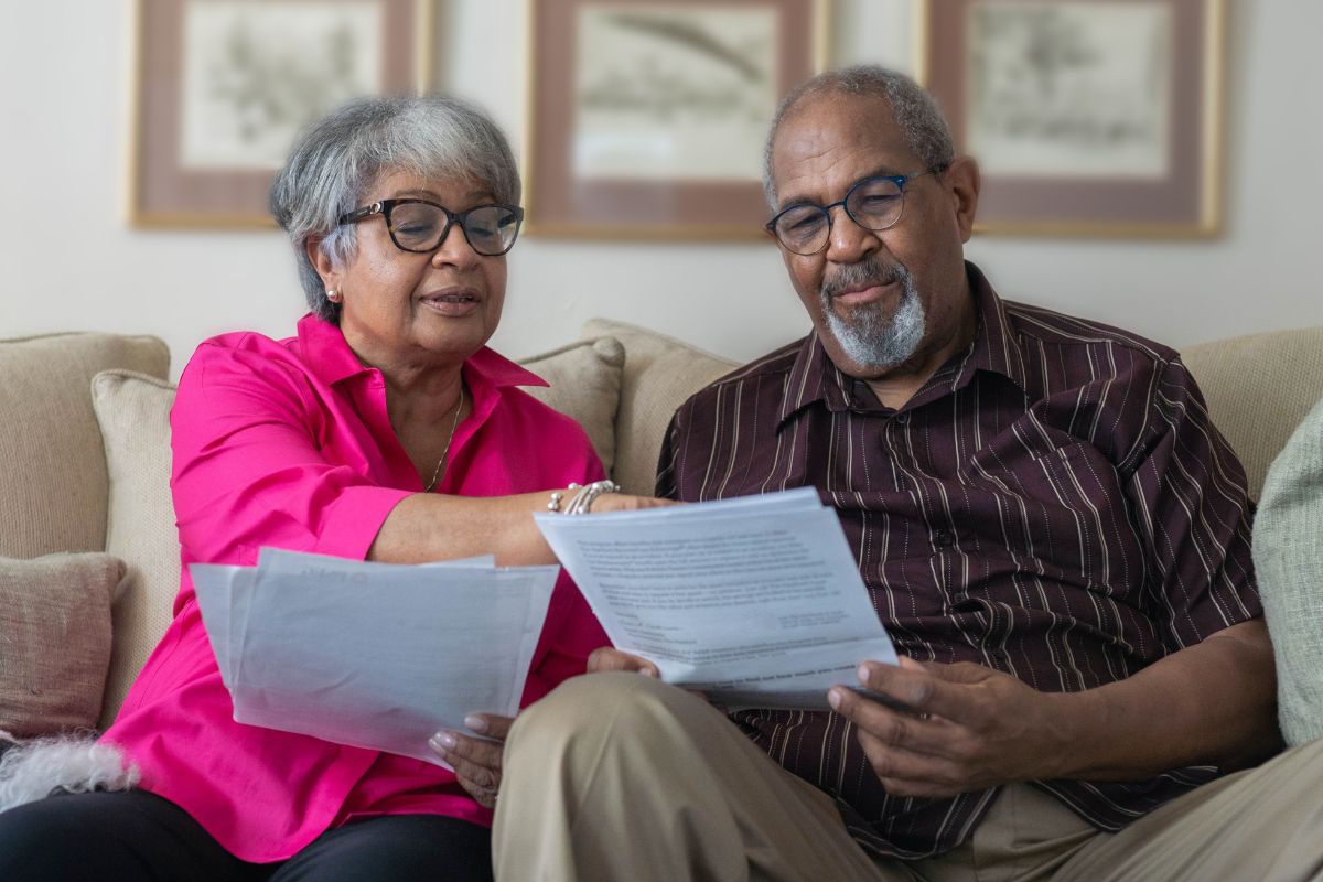 A picture of an elderly couple reviewing their papers.