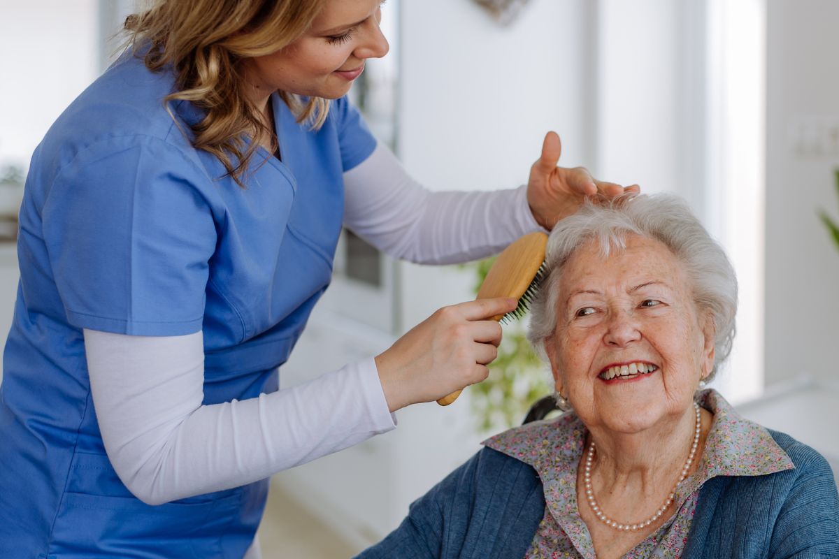 A picture of a caretaker looking after an elderly woman.