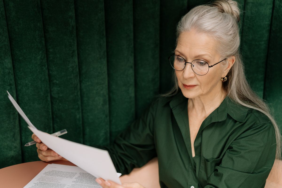 A picture of an elderly woman reviewing her finances.