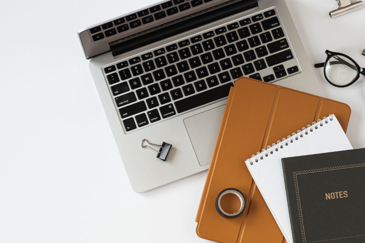 A picture of gadgets and a notebook.