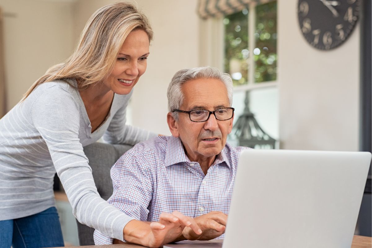 A picture of someone helping an elderly person.