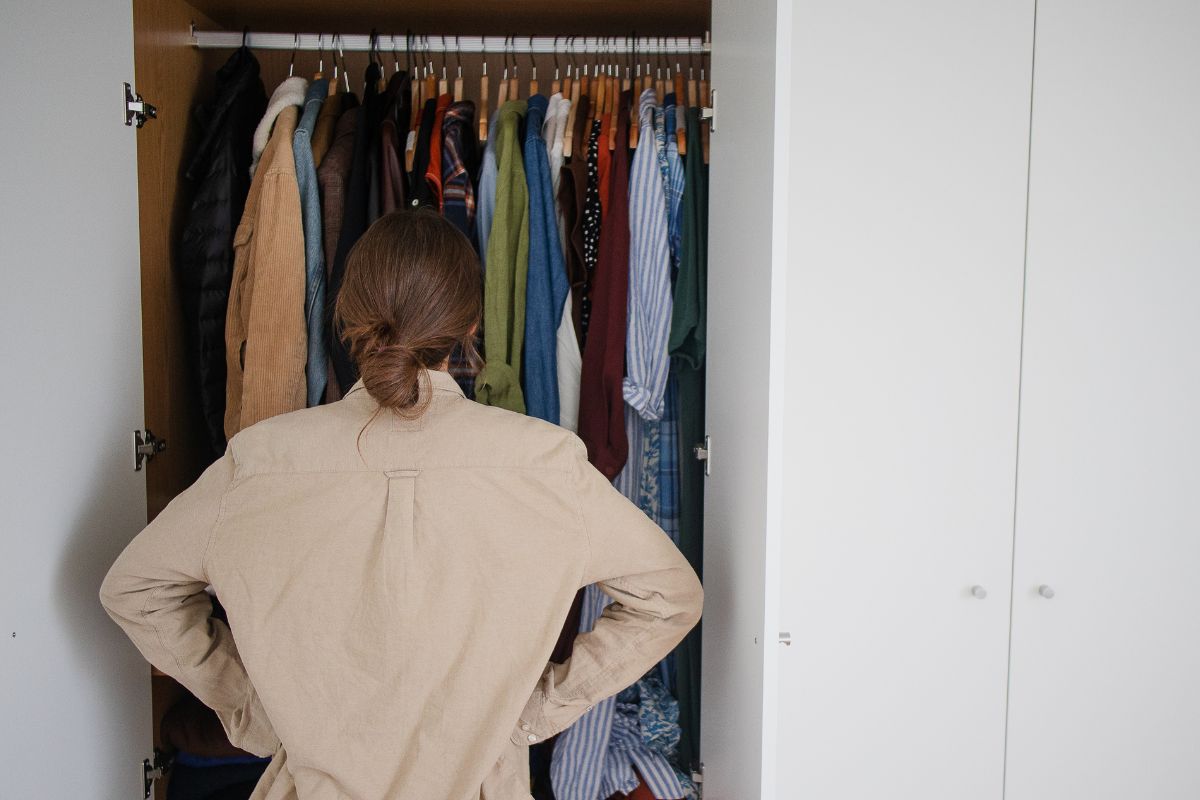 A picture of someone looking at their closet.