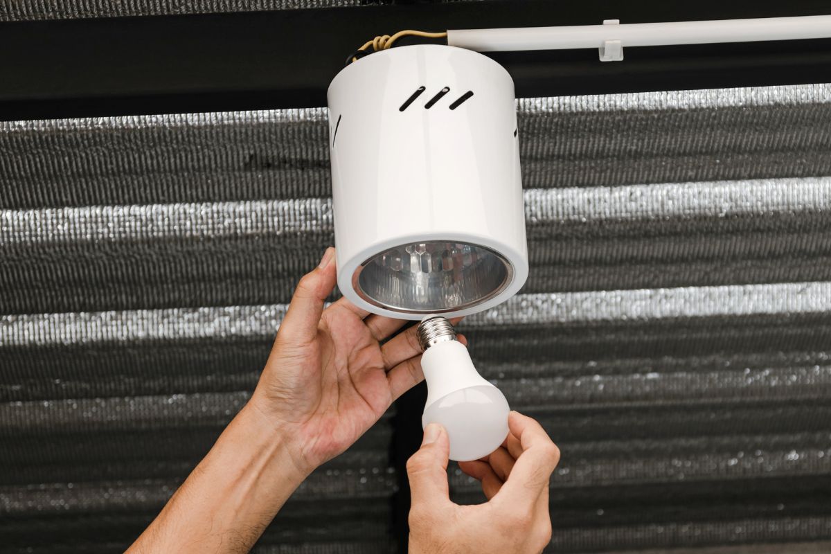 A picture of someone switching to LED lights.