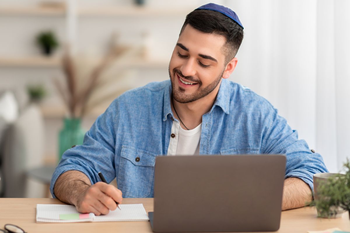 A picture of someone smiling while taking notes.