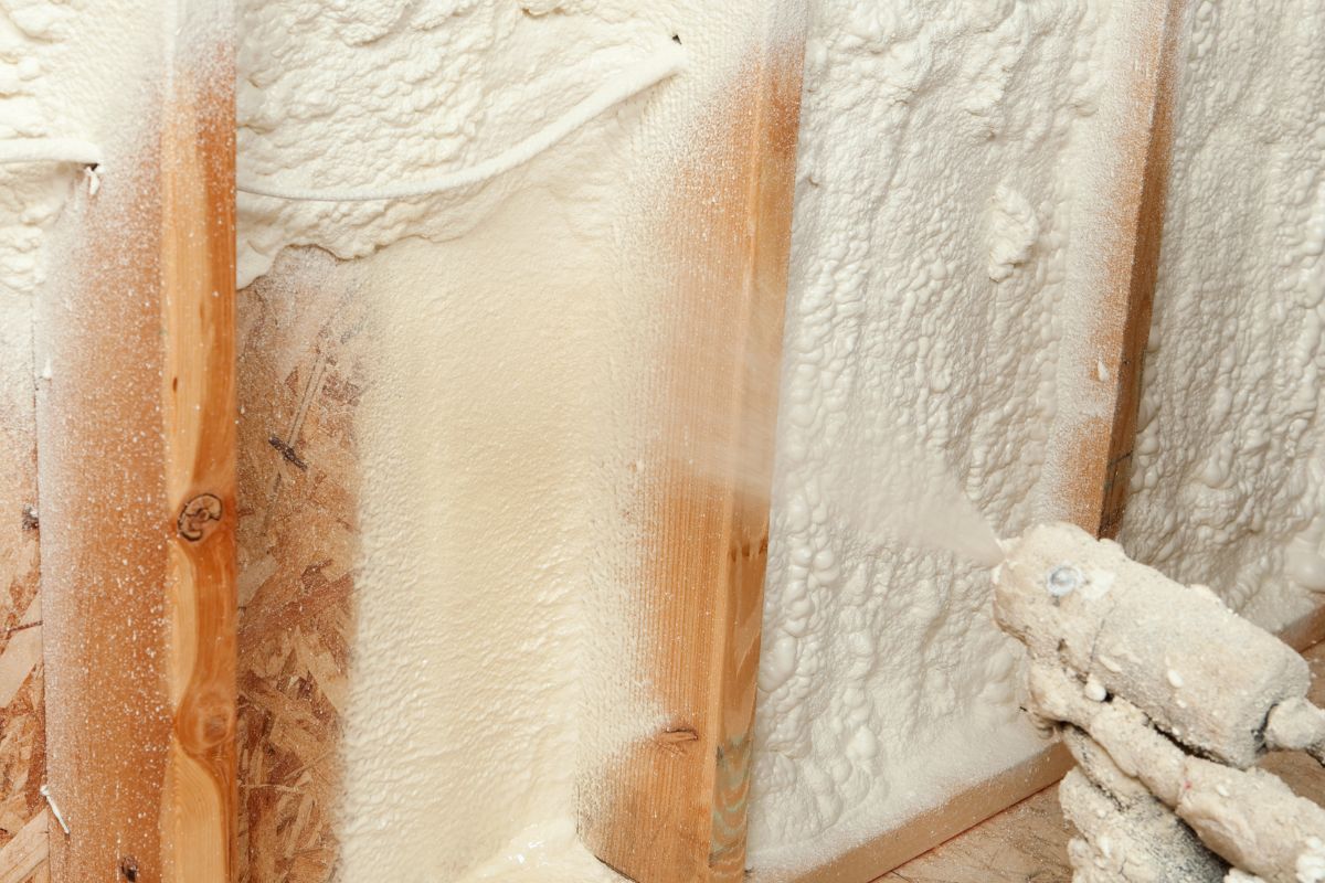 A picture of someone putting insulation.