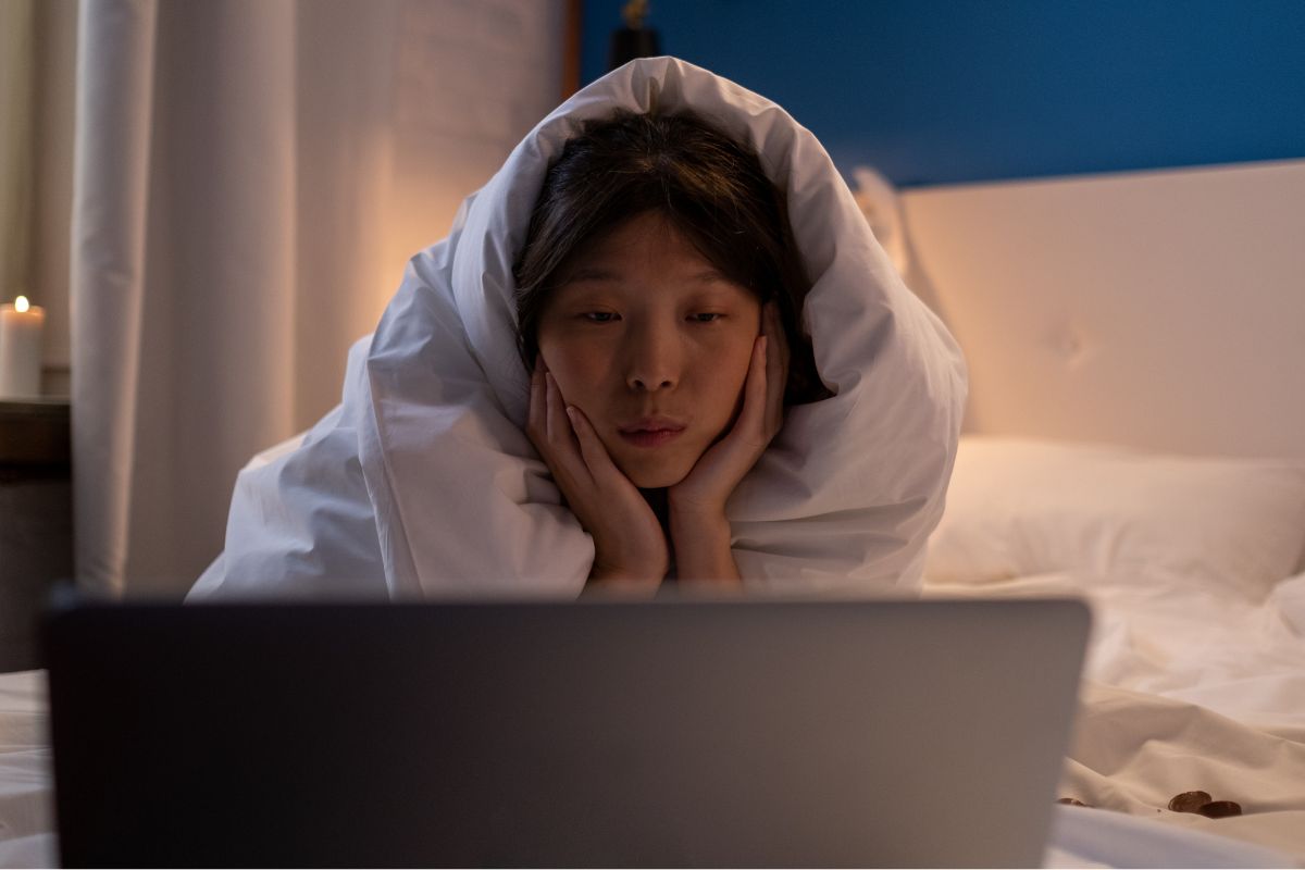 A picture of a woman watching something.