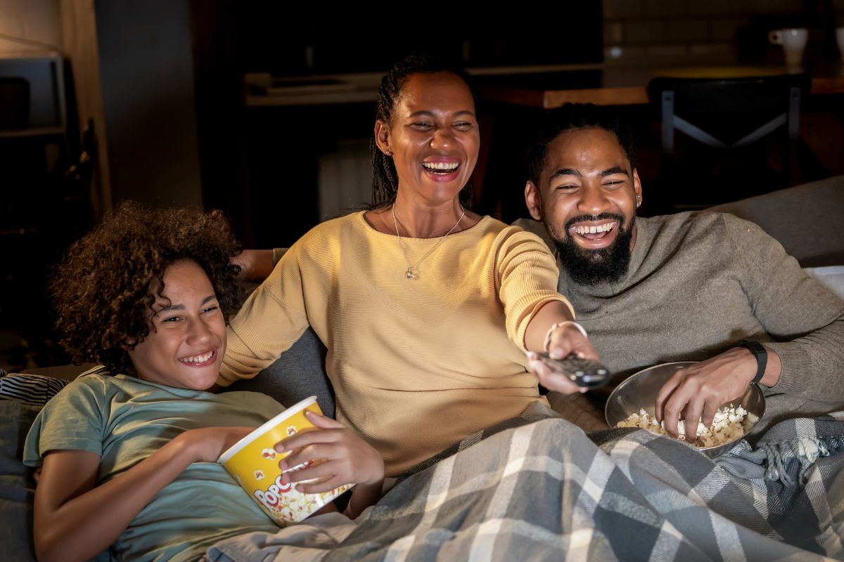 A picture of adults watching something.