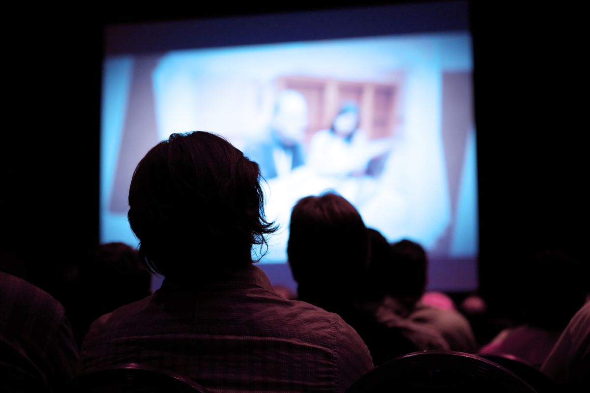 A picture of people watching in a cinema.