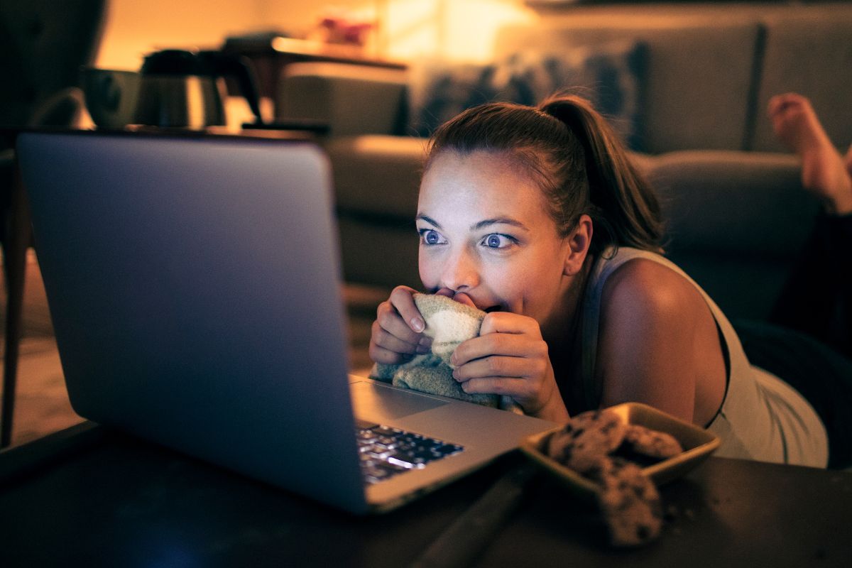 A picture of a woman watching something.