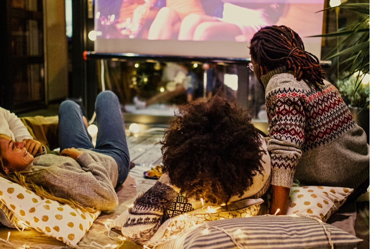 A picture of adults watching a movie.