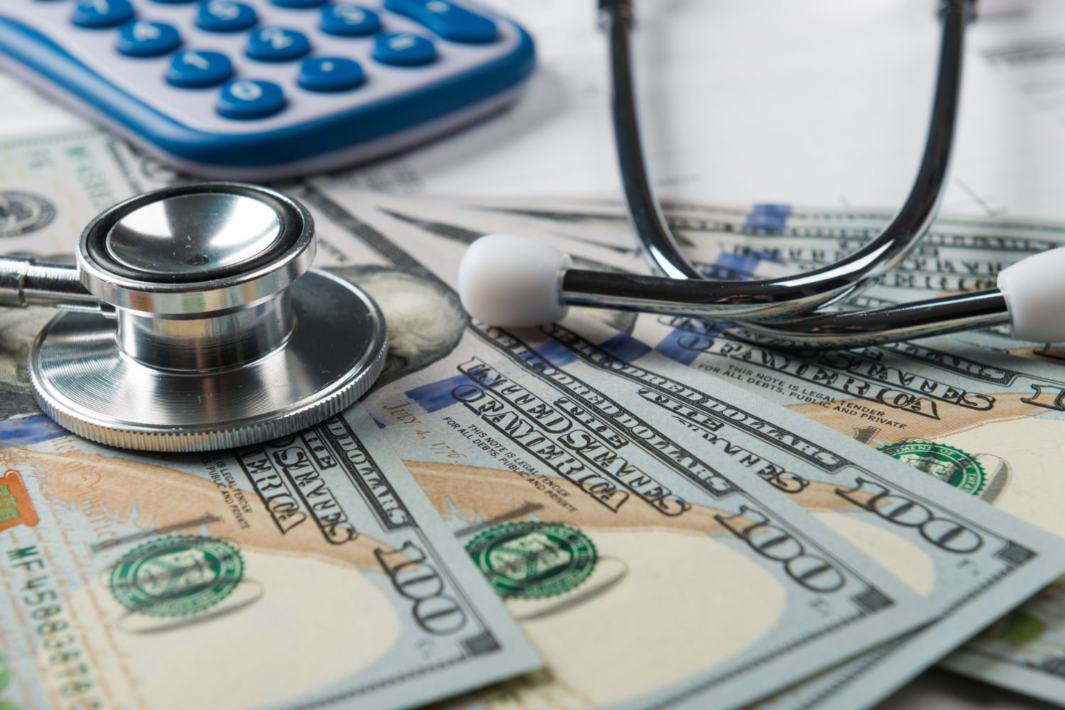 A picture of money and a stethoscope.