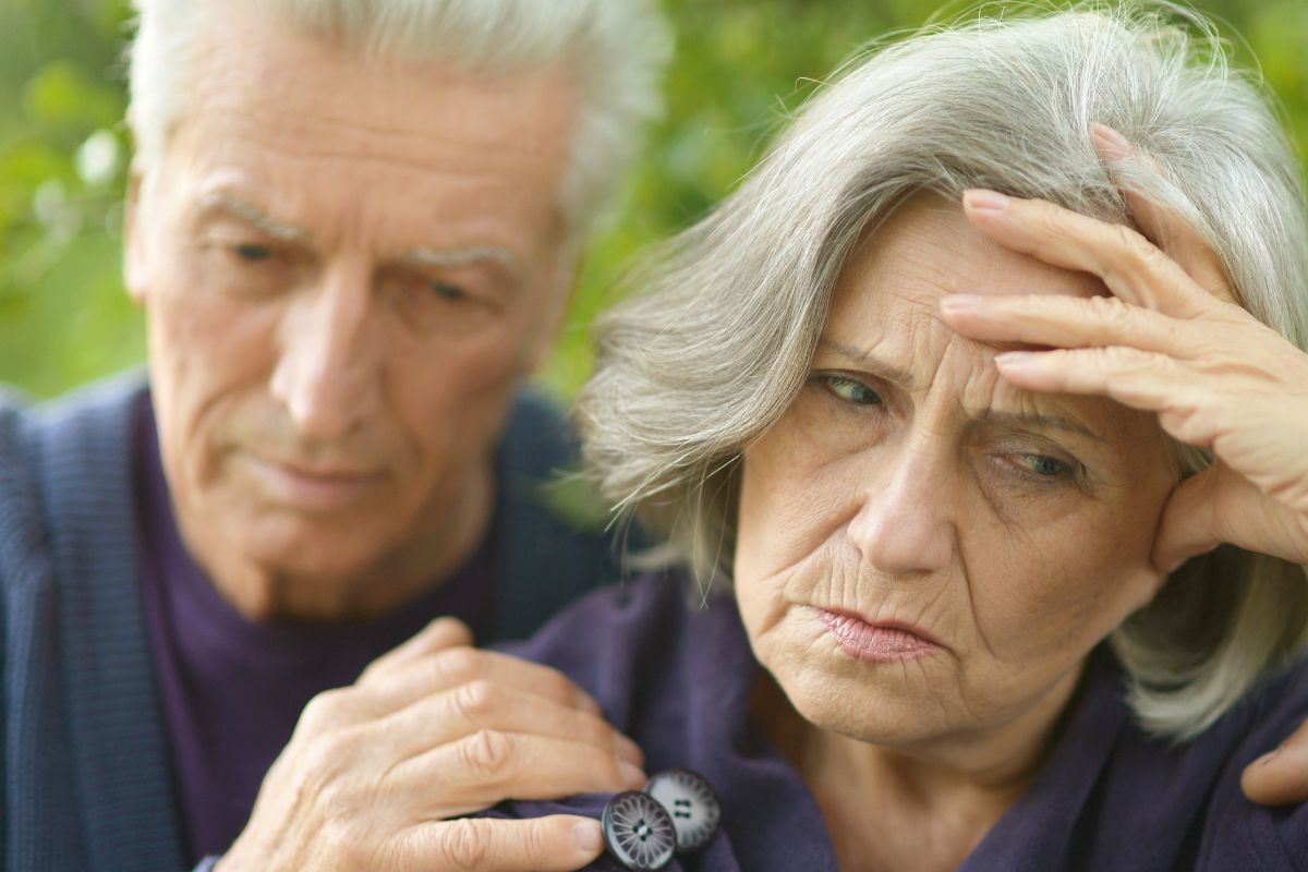A picture of a sad elderly couple.