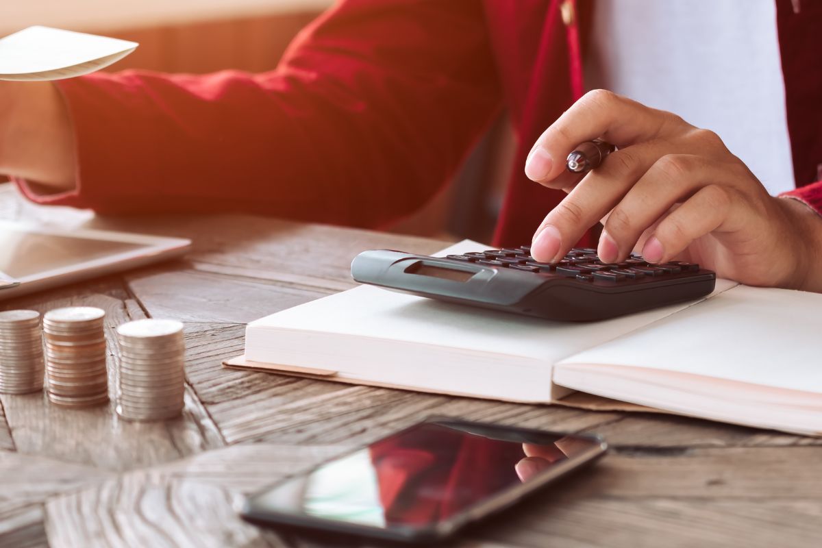 A picture of someone calculating their budget.