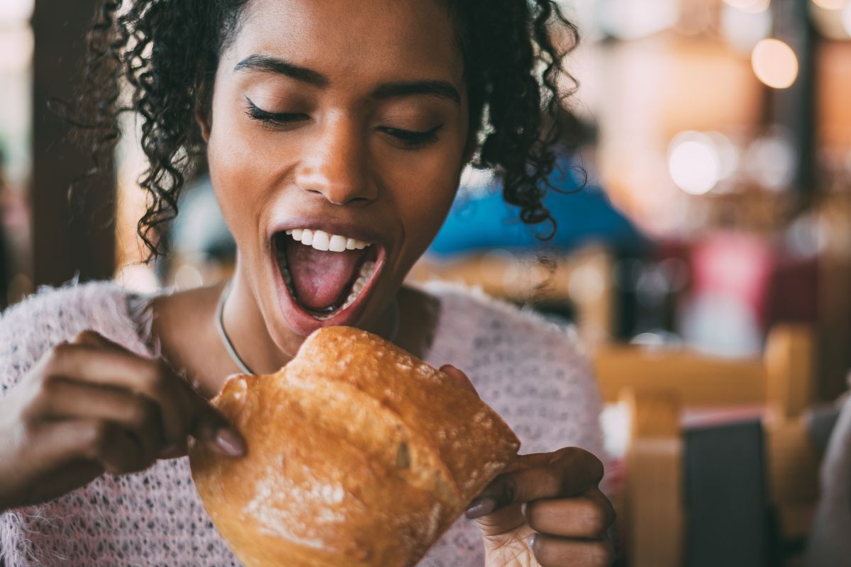 A picture of someone eating restaurant bread.