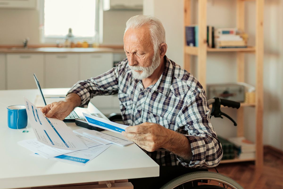 A picture of an elderly man reviewing his finances.