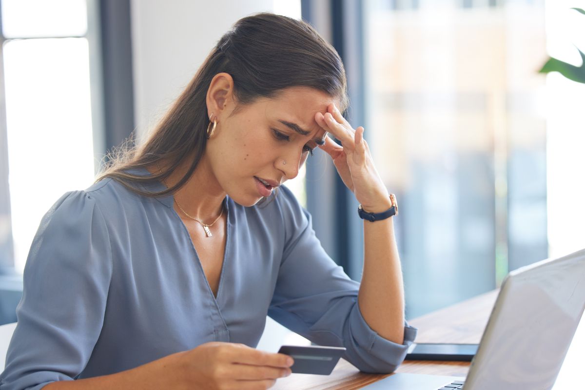A picture of someone having a headache due to credit.