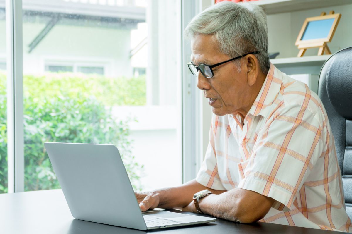 A picture of an elderly person researching.