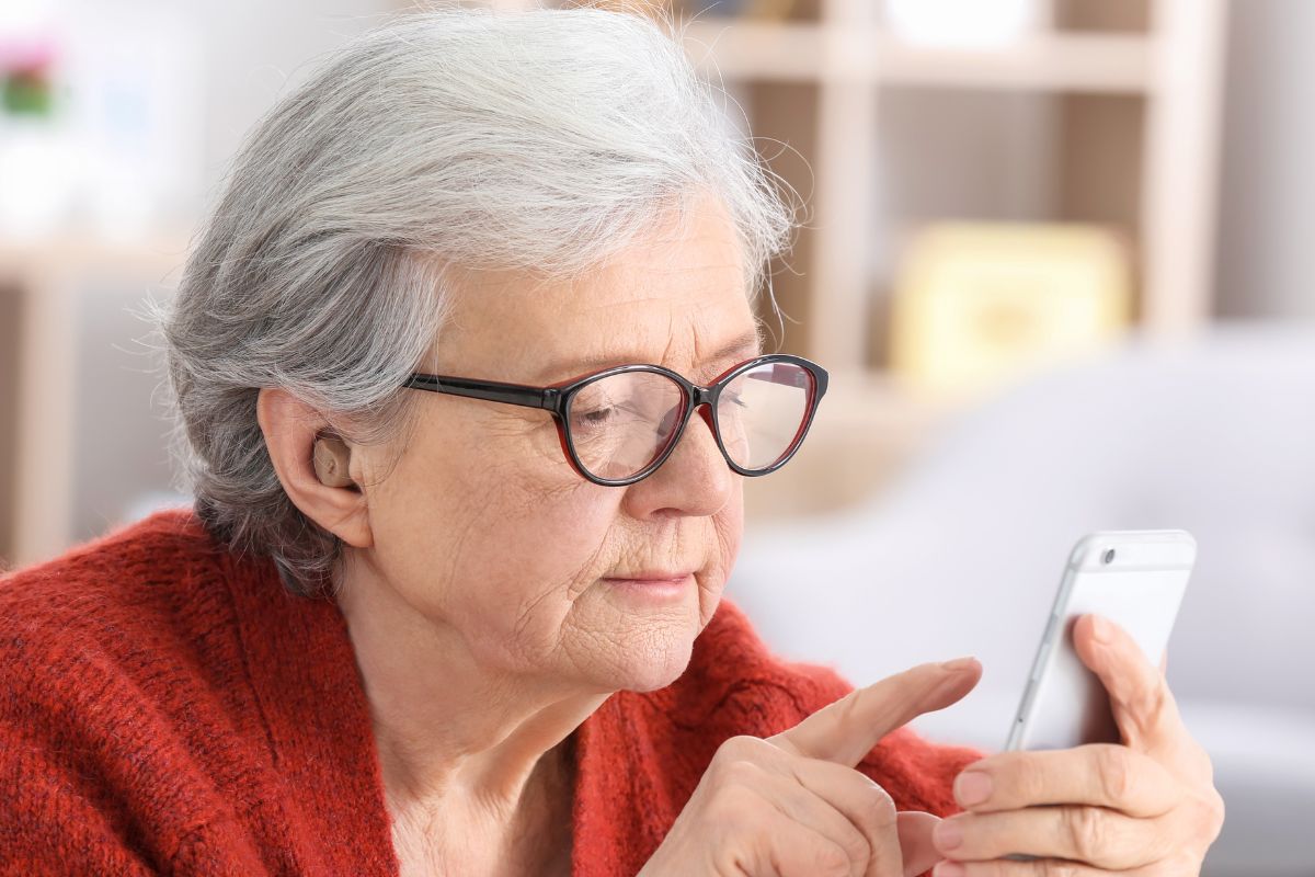 A picture of an elderly woman using their phone.