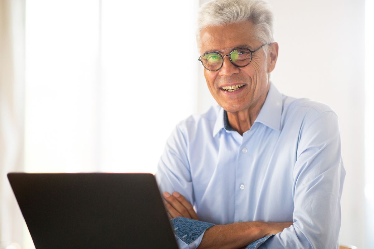 A picture of an elderly man using their laptop.