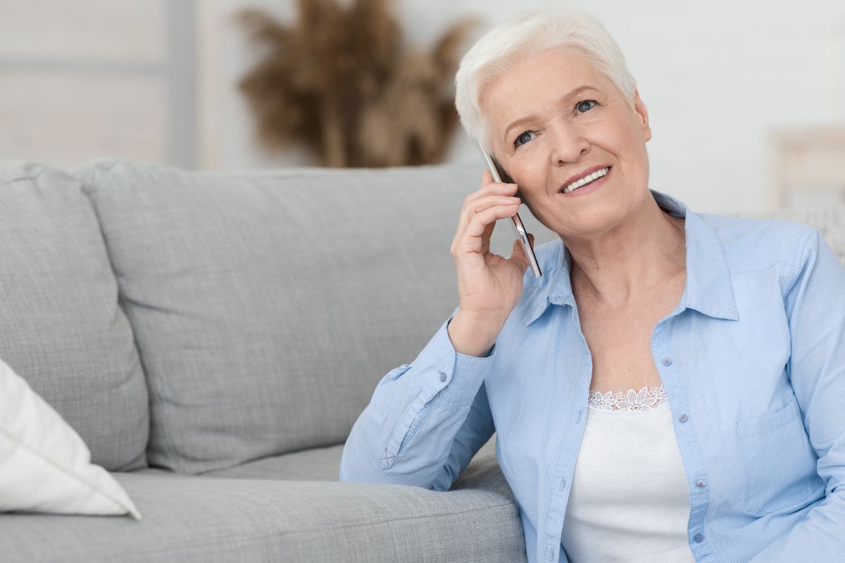 A picture of an elderly woman speaking to someone.
