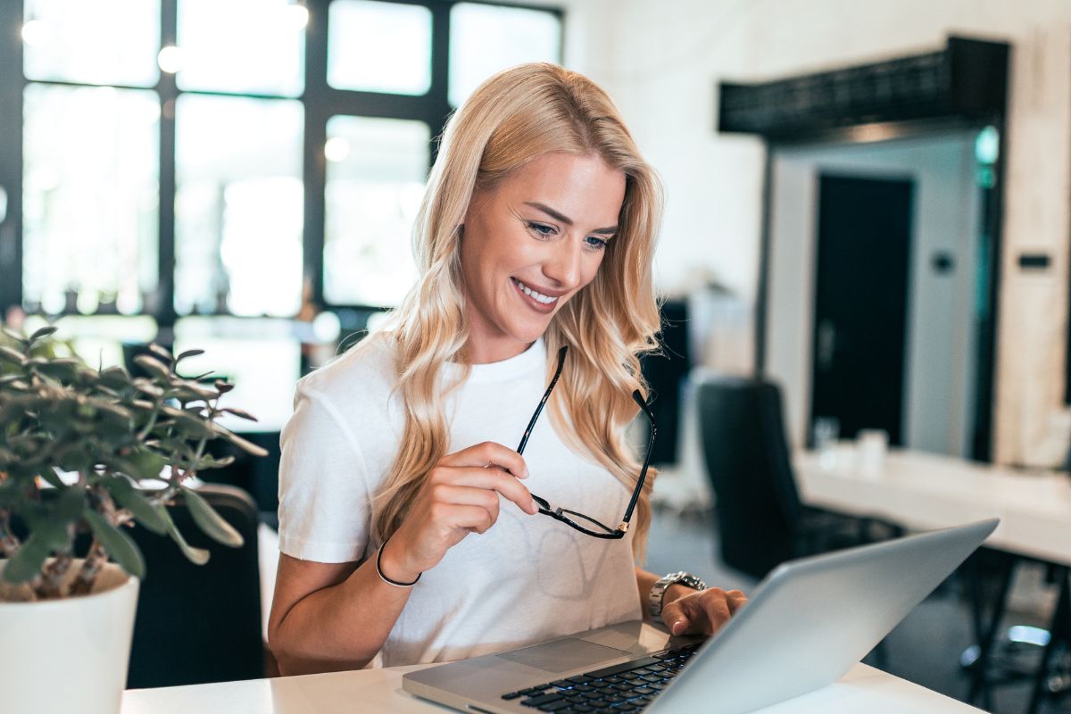 A picture of someone looking at their laptop.