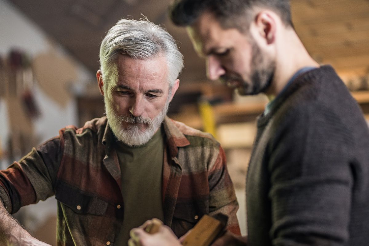 A picture of a senior working with someone.