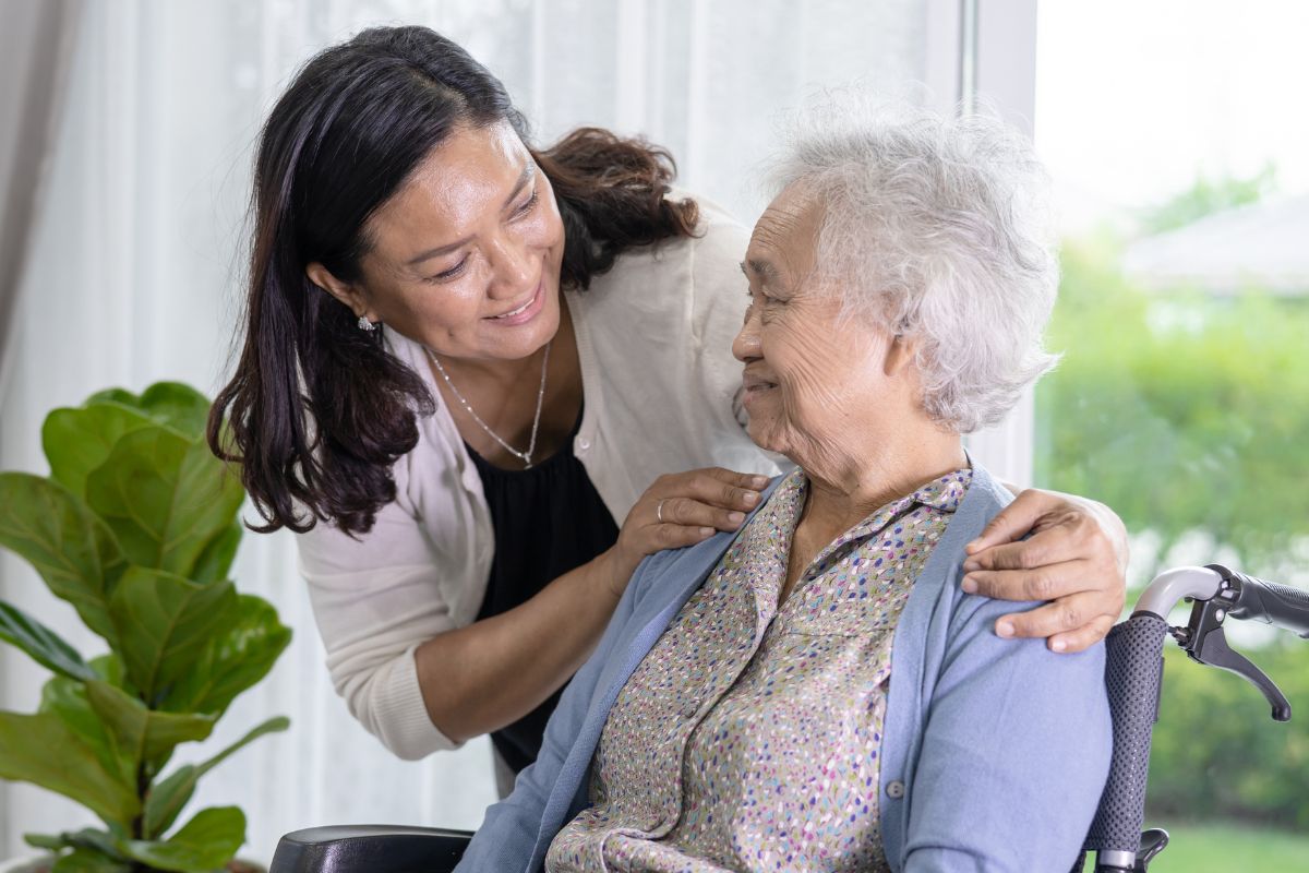 A picture of a senior citizen being cared for by someone.